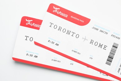 Photo of Travel agency. Flight tickets on light background, top view