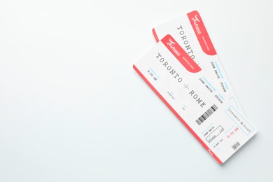 Photo of Travel agency. Flight tickets on light background, top view. Space for text