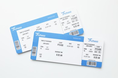 Photo of Travel agency. Flight tickets on light background, top view