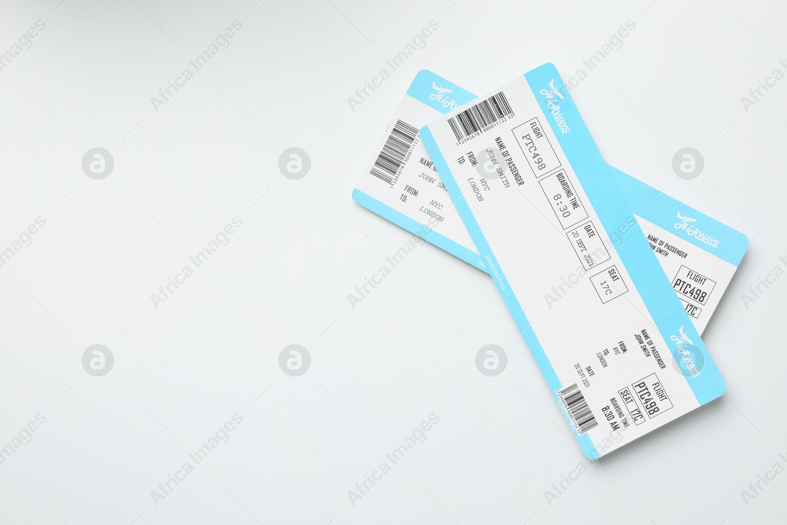 Photo of Travel agency. Flight tickets on light background, top view. Space for text