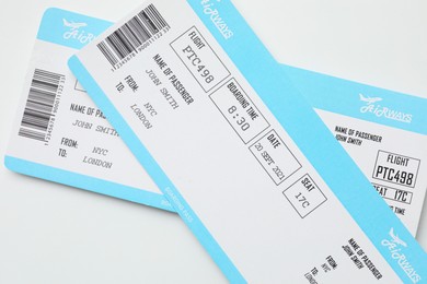 Photo of Travel agency. Flight tickets on light background, top view