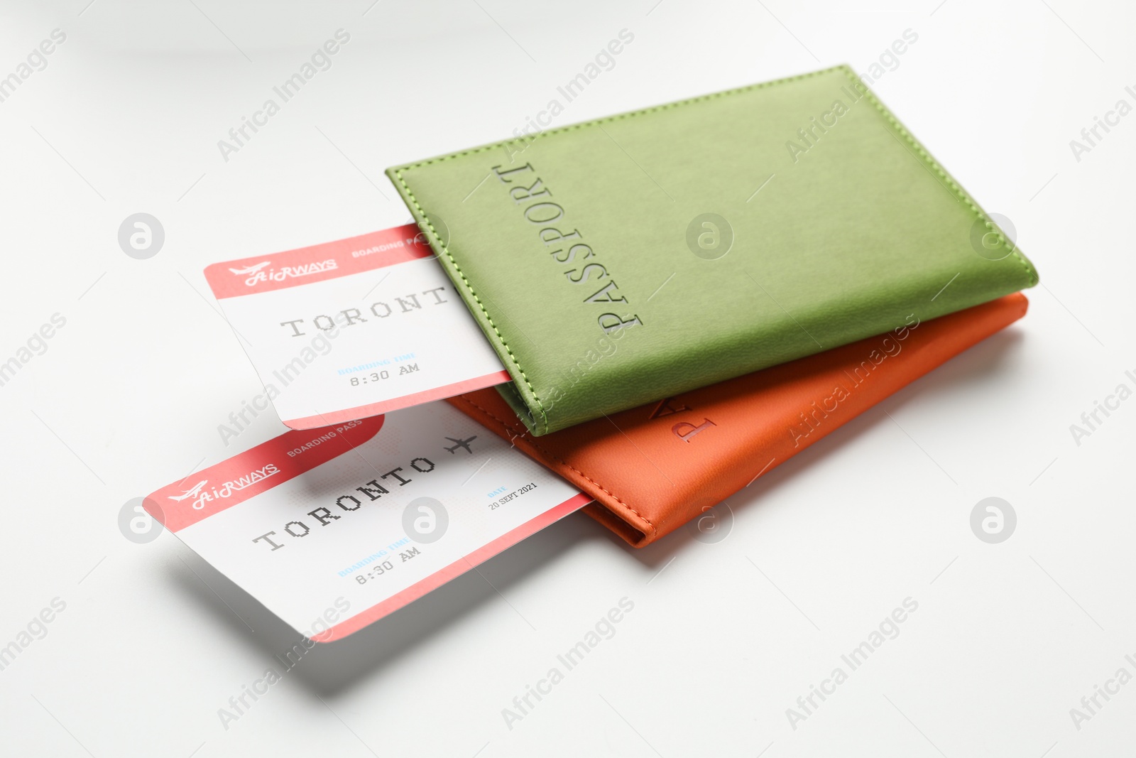 Photo of Travel agency. Flight tickets and passports on light background, closeup