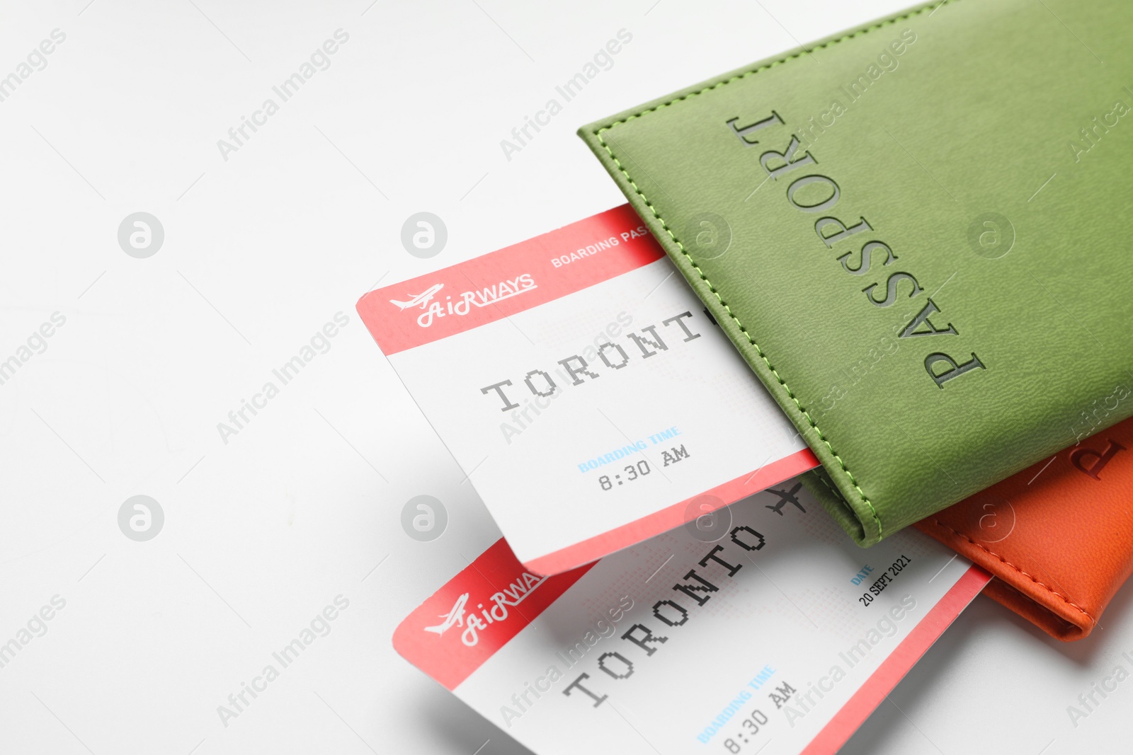 Photo of Travel agency. Flight tickets and passports on light background, closeup. Space for text