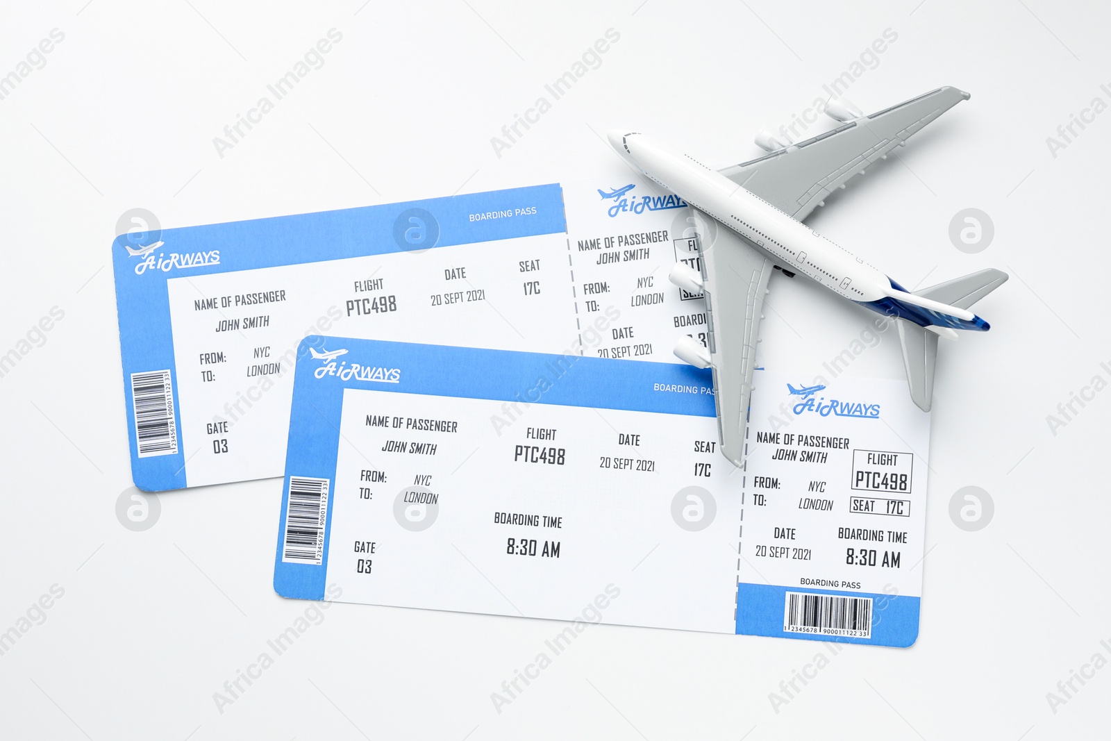 Photo of Travel agency. Flight tickets and plane model on light background, flat lay