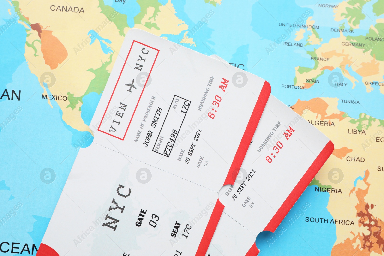 Photo of Travel agency. Flight tickets on world map, top view