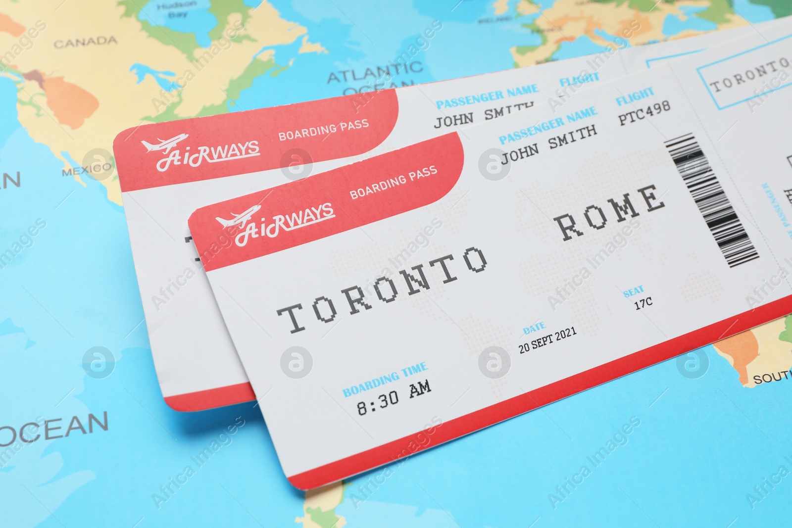 Photo of Travel agency. Flight tickets on world map, closeup