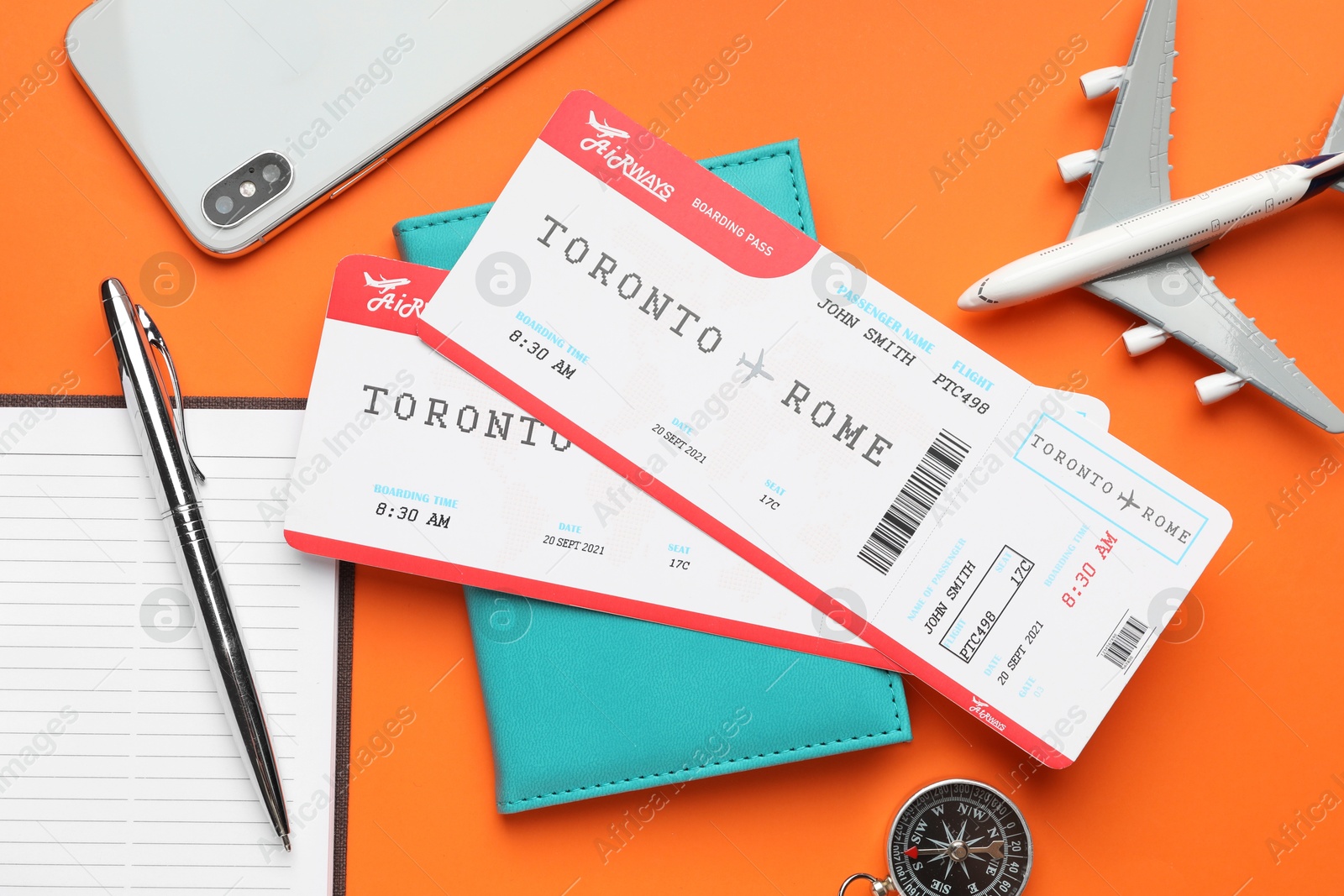 Photo of Travel agency. Flat lay composition with flight tickets on orange background