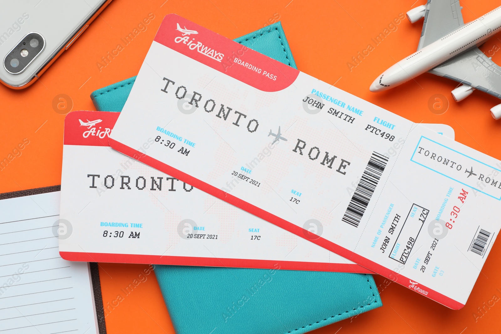 Photo of Travel agency. Flat lay composition with flight tickets on orange background