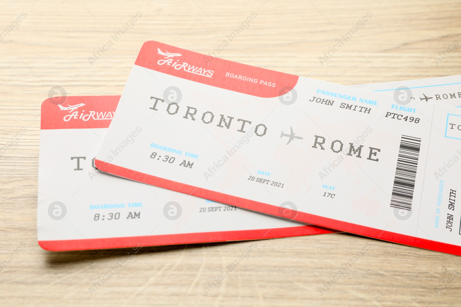 Photo of Travel agency. Flight tickets on wooden table, closeup