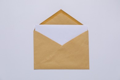 Photo of Kraft paper envelope with letter on white background, top view. Mockup for design