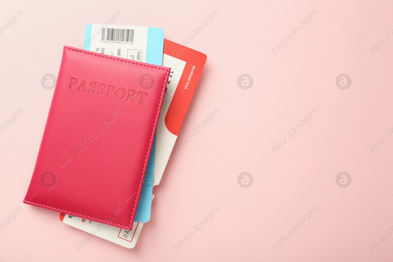 Photo of Passport with tickets on pink background, top view. Space for text