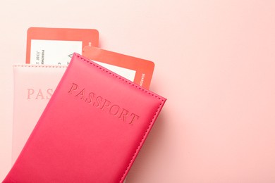 Photo of Passports with tickets on pink background, flat lay. Space for text