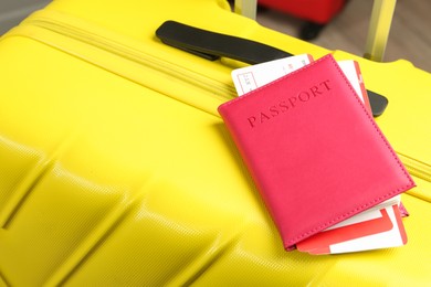 Photo of Passport with tickets on yellow suitcase, closeup