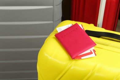 Photo of Passport with tickets on yellow suitcase, closeup