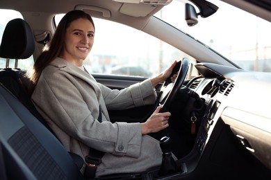 Photo of Driver behind steering wheel of modern car