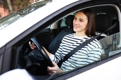 Photo of Driver behind steering wheel of modern car, view from outside