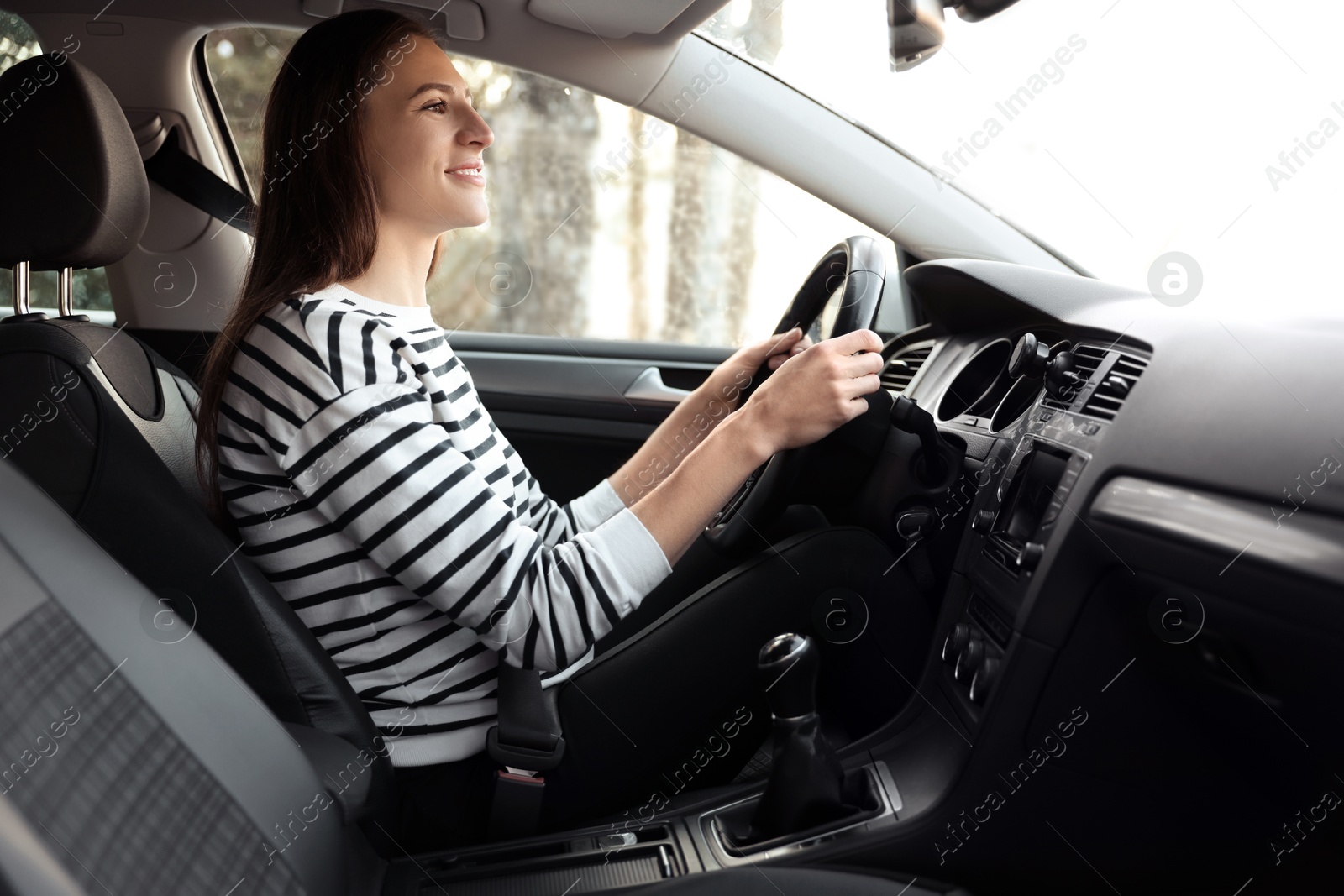 Photo of Driver behind steering wheel of modern car