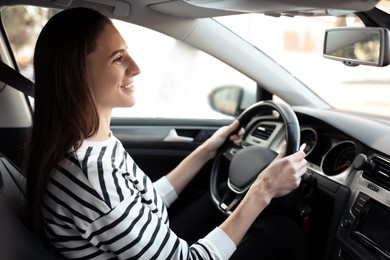 Photo of Driver behind steering wheel of modern car