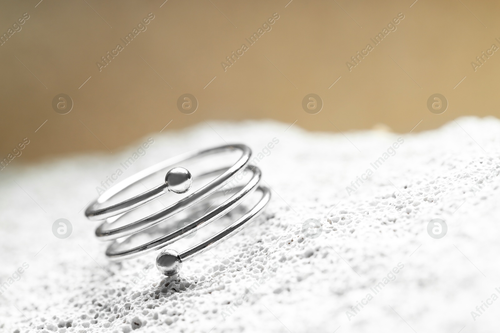 Beautiful silver ring on stone surface, closeup. Space for text Photo of Beautiful silver ring on stone surface, closeup. Space for text