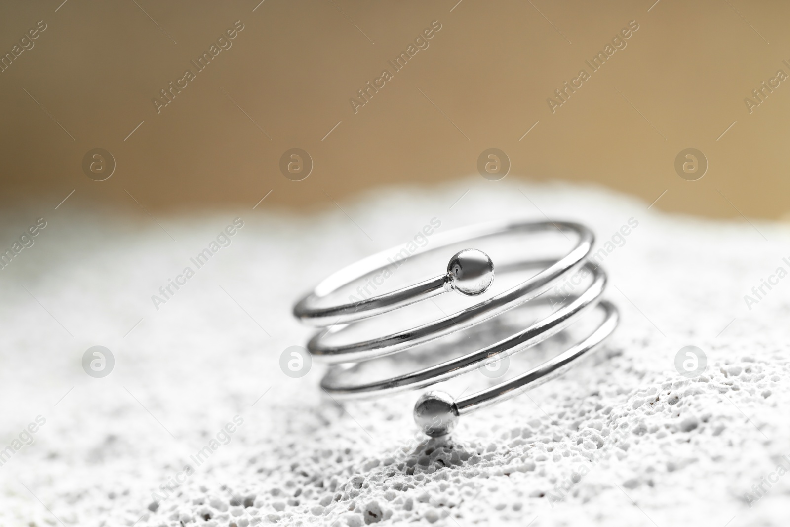 Beautiful silver ring on stone surface, closeup. Space for text Photo of Beautiful silver ring on stone surface, closeup. Space for text