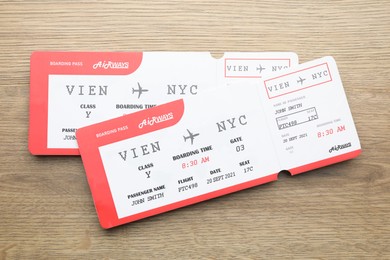 Photo of Travel agency. Flight tickets on wooden table, top view