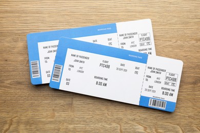 Photo of Travel agency. Flight tickets on wooden table, top view