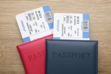 Photo of Travel agency. Flight tickets and passports on wooden table, top view