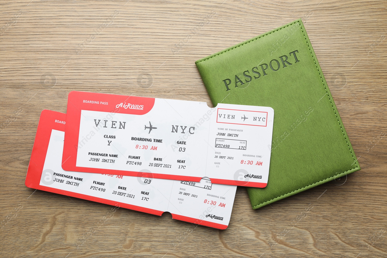 Photo of Travel agency. Flight tickets and passport on wooden table, flat lay