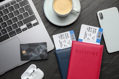 Photo of Travel agency. Flat lay composition with flight tickets and credit card on dark textured table