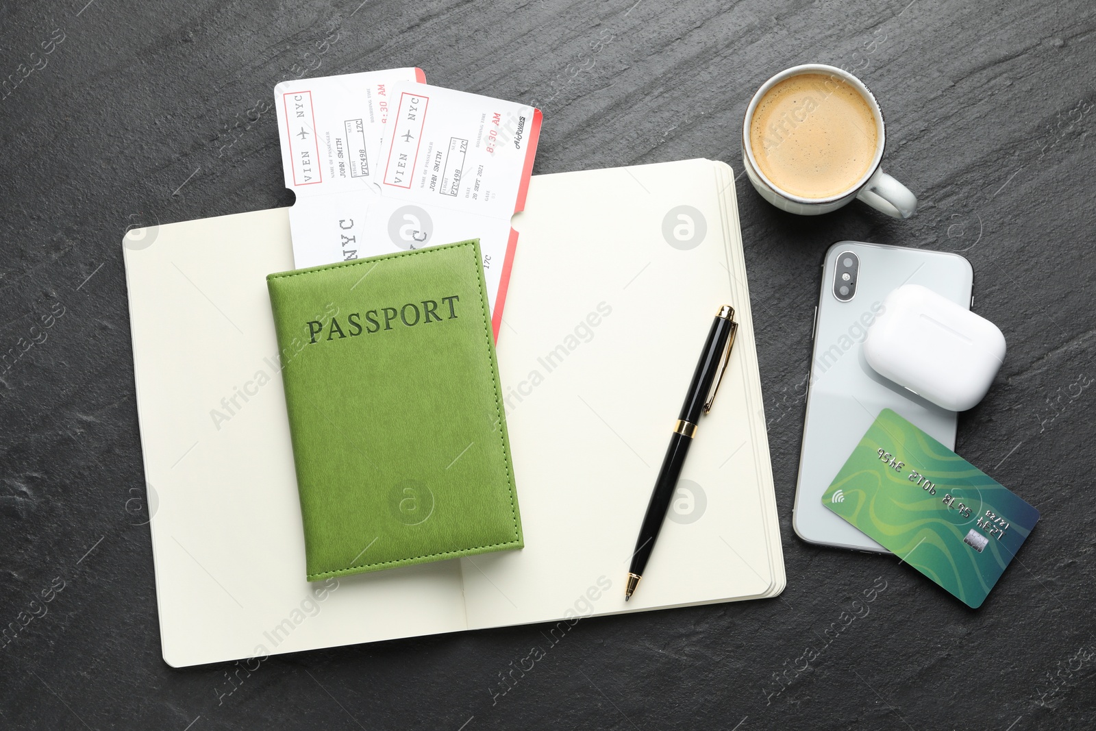 Photo of Travel agency. Flat lay composition with flight tickets on dark textured table