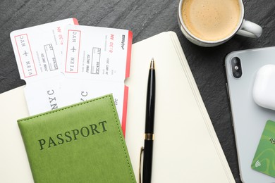 Photo of Travel agency. Flat lay composition with flight tickets on dark textured table