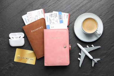 Photo of Travel agency. Flat lay composition with flight tickets and passports on dark textured table