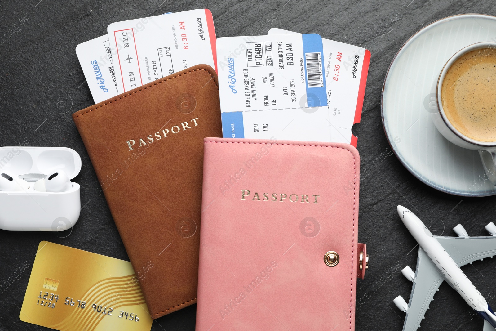 Photo of Travel agency. Flat lay composition with flight tickets and passports on dark textured table