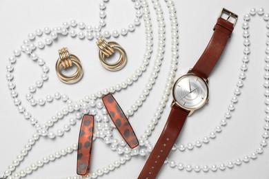 Photo of Flat lay composition with jewelry and watch on light grey background