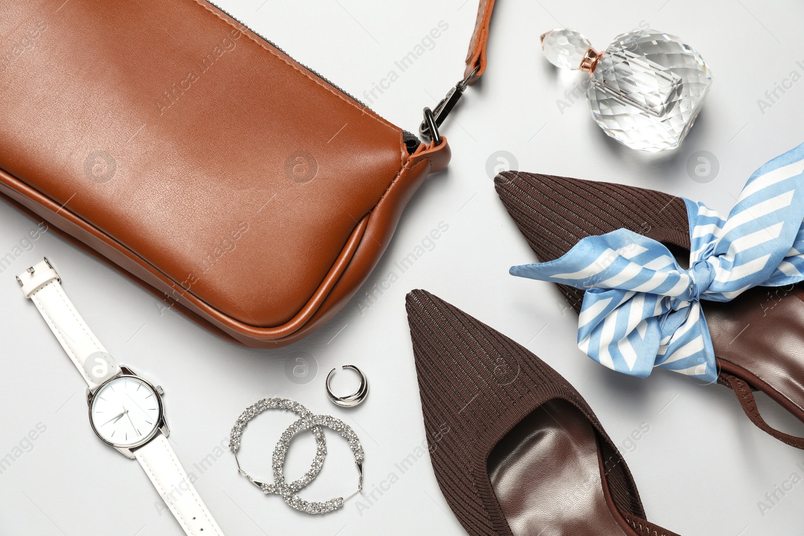 Photo of Flat lay composition with jewelry, accessories and shoes on light grey background