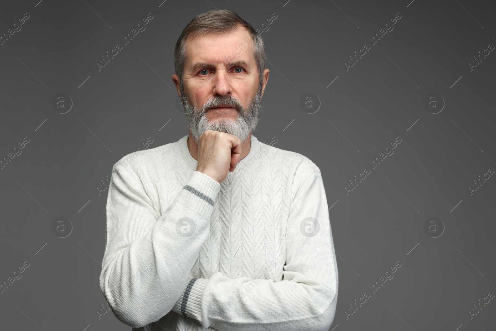 Photo of Portrait of mature man on grey background, space for text