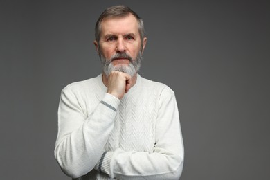 Photo of Portrait of mature man on grey background, space for text