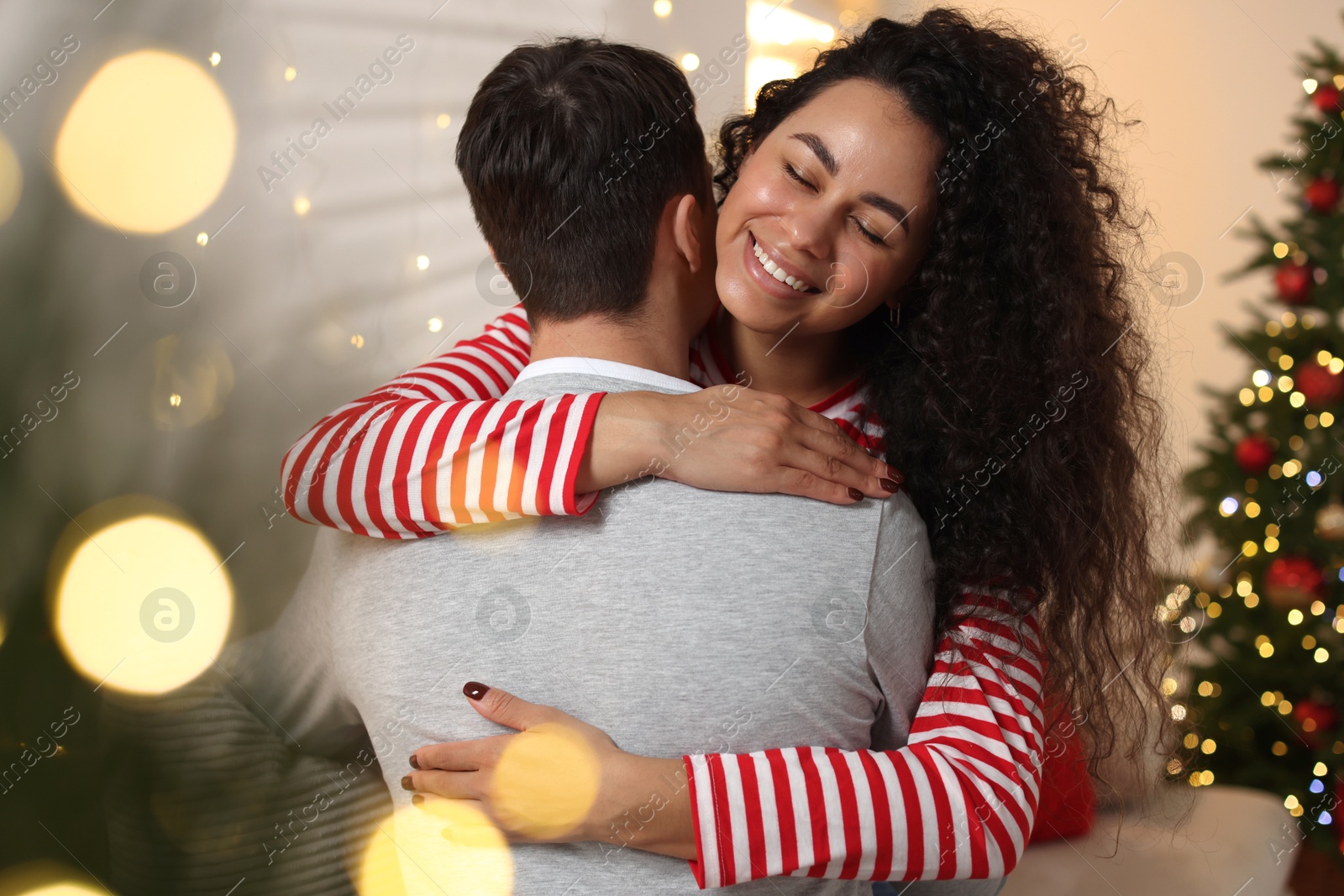 Photo of Happy couple hugging at home. Christmas celebration