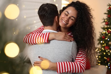 Photo of Happy couple hugging at home. Christmas celebration