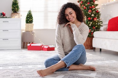 Portrait of beautiful young woman at home. Christmas celebration