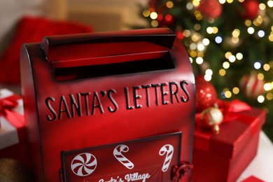 Photo of Santa Claus mailbox and Christmas decor indoors, closeup