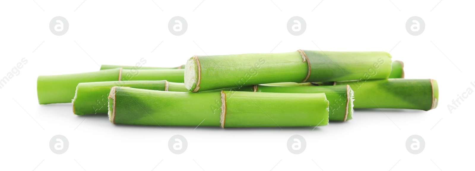 Photo of Cut green bamboo stems isolated on white