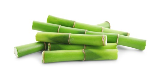 Photo of Cut green bamboo stems isolated on white