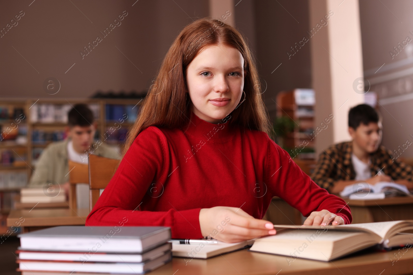 Photo of Girl studying at desk in public library