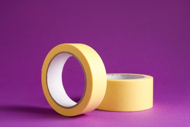 Rolls of masking tapes on violet background