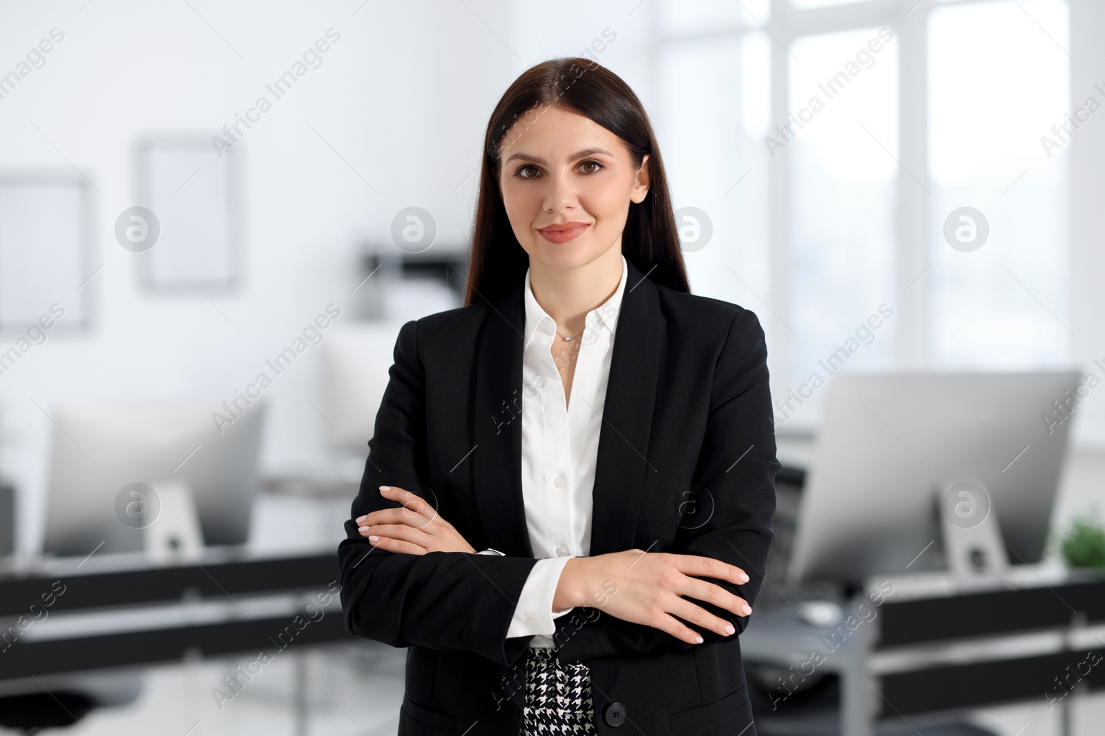 Photo of Portrait of banker with crossed arms in office