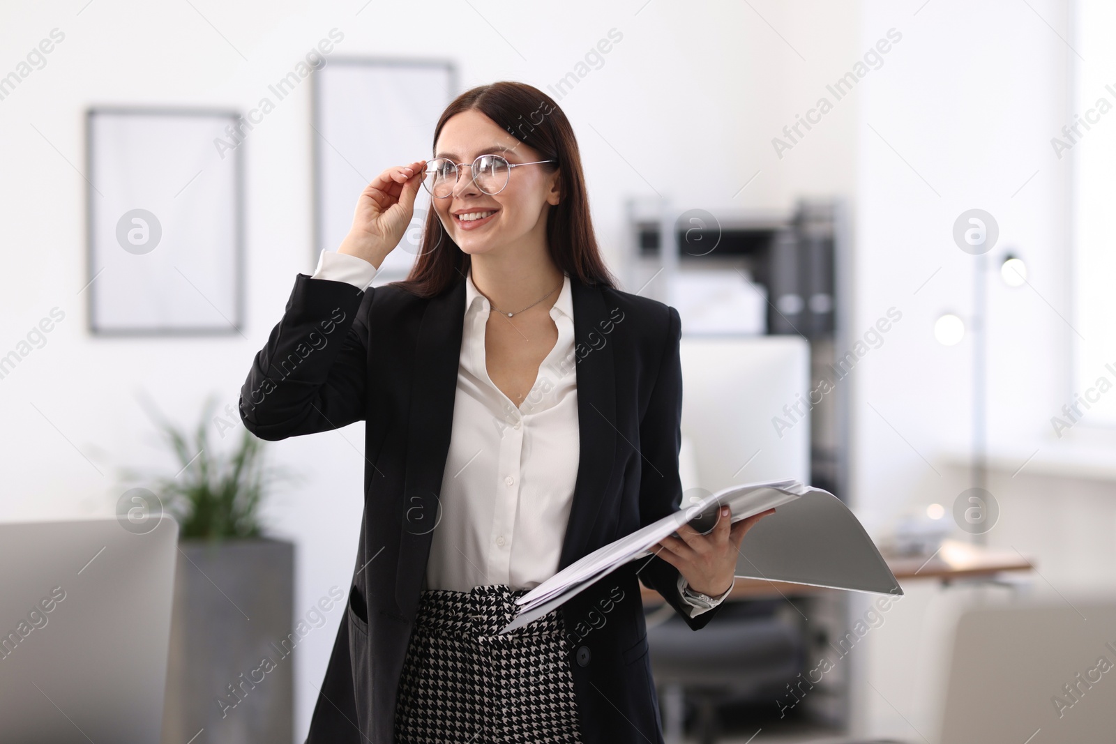 Photo of Portrait of banker with folder in office