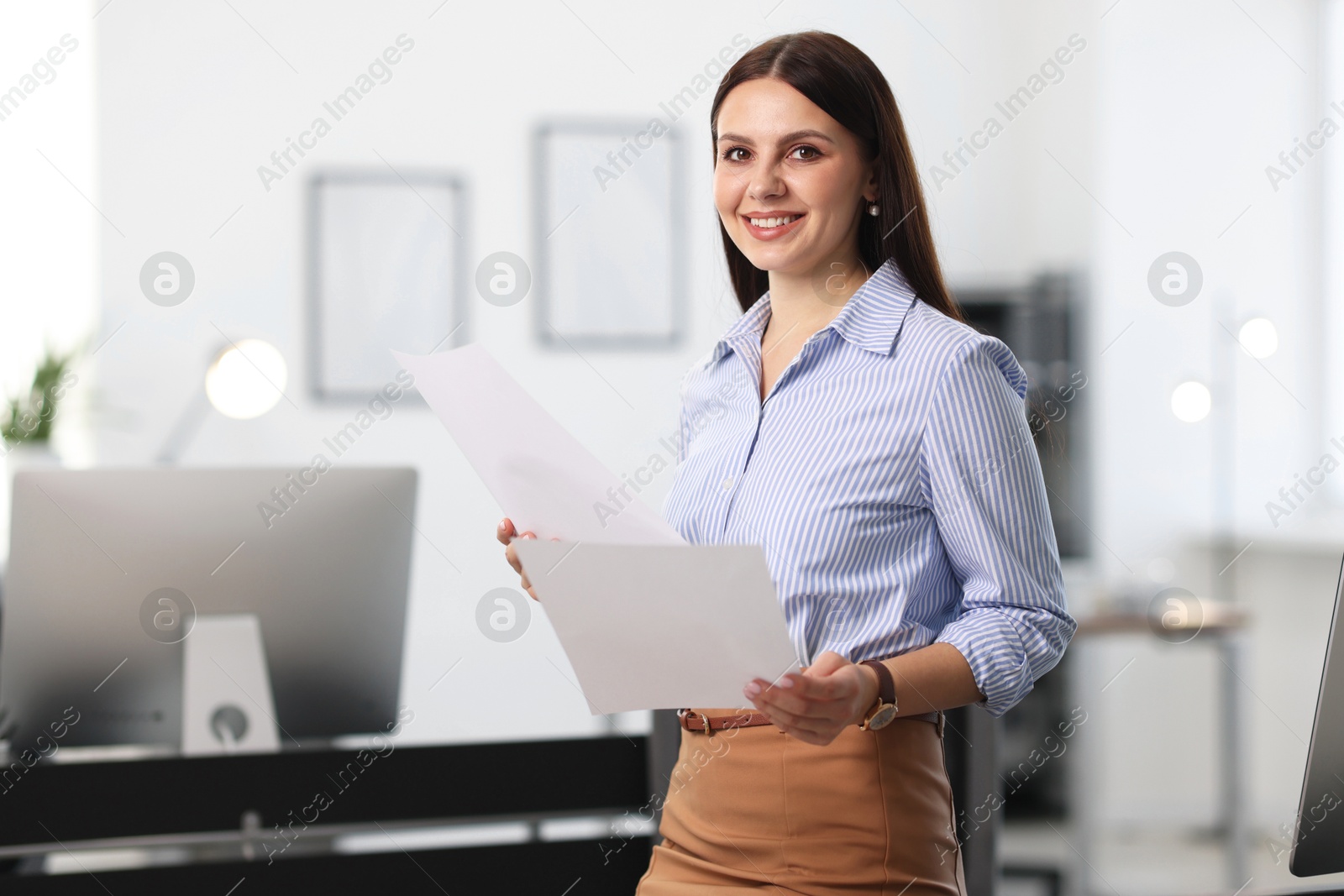 Photo of Portrait of banker with documents in office, space for text