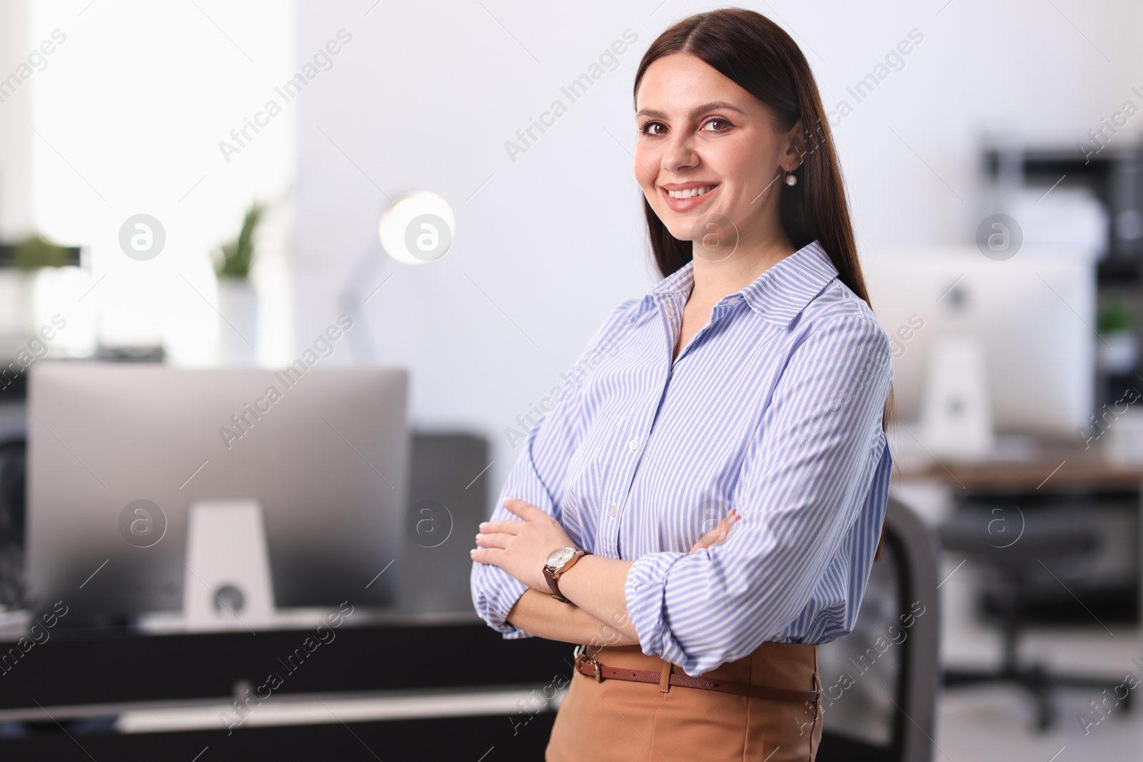 Photo of Portrait of banker with crossed arms in office, space for text