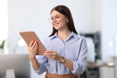 Photo of Portrait of banker using tablet in office